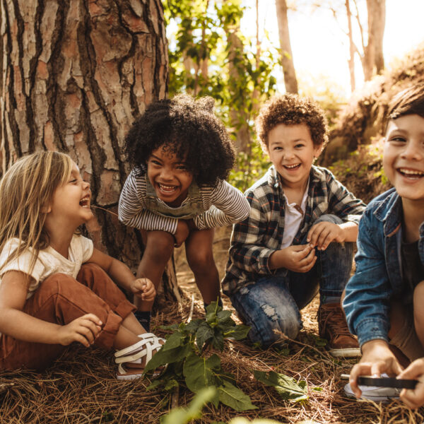 Group,Of,Cute,Kids,Sitting,Together,In,Forest,And,Looking
