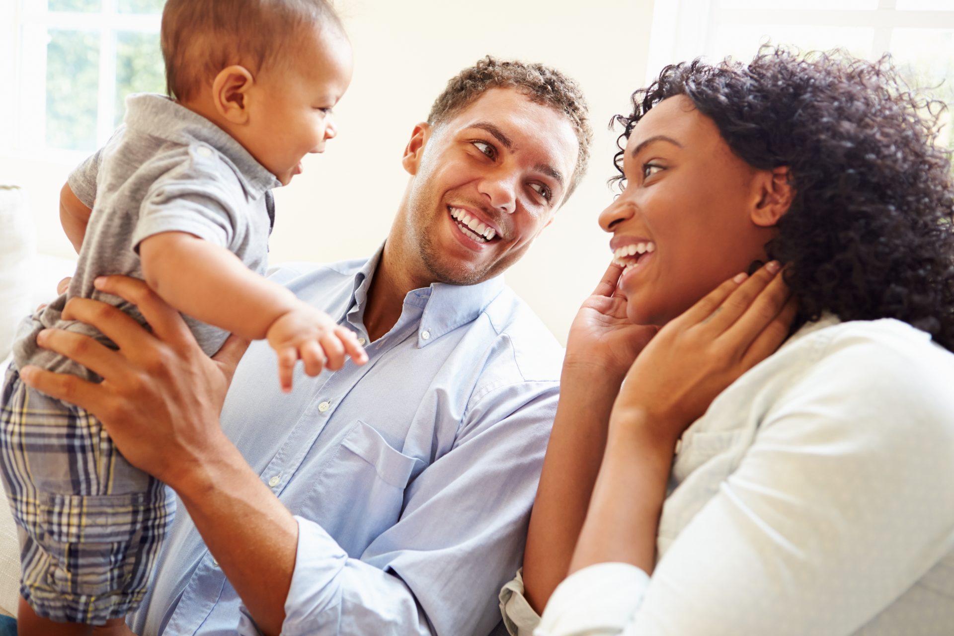 Young,Family,Playing,With,Happy,Baby,Son,At,Home