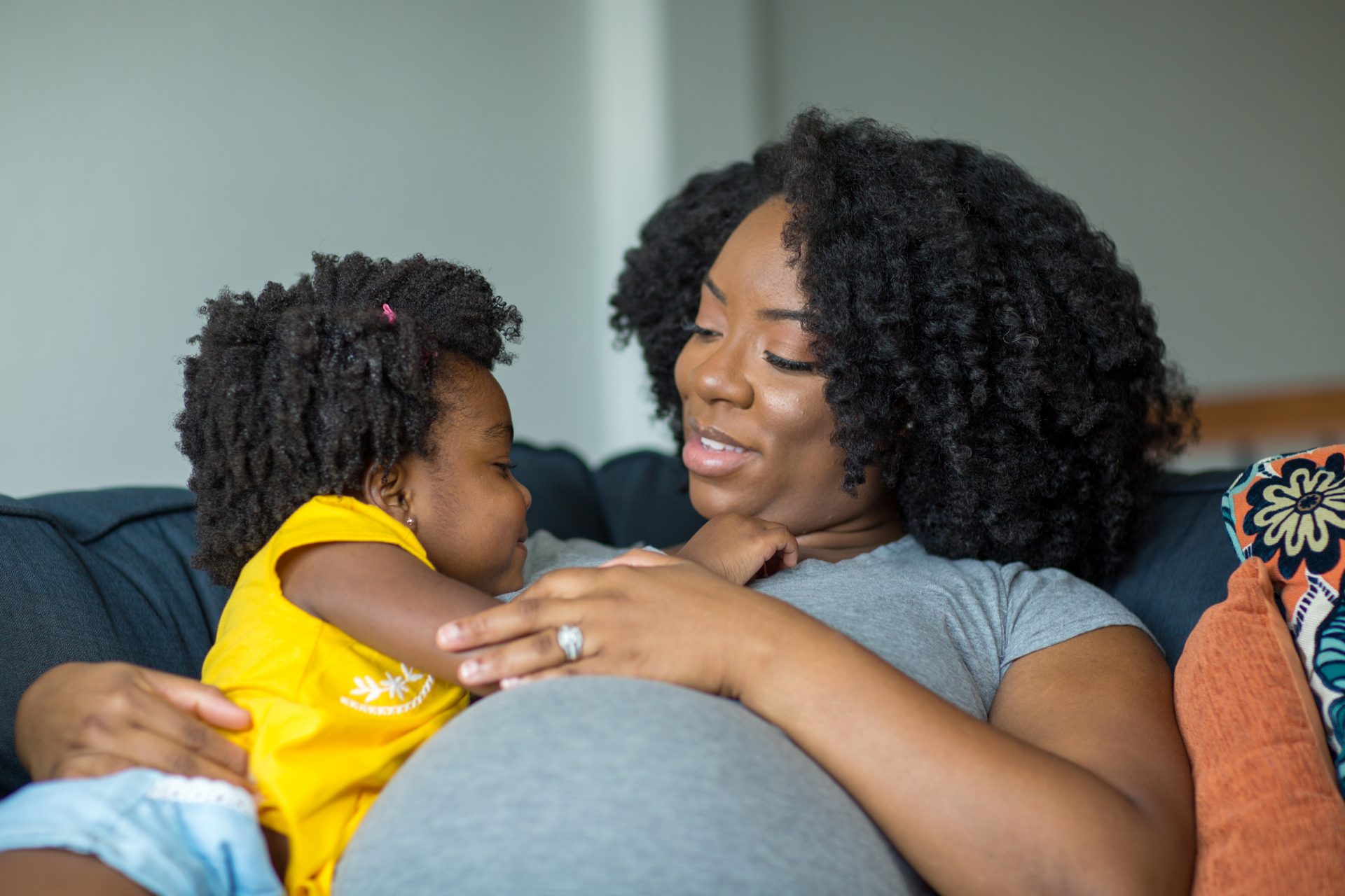 African,American,Little,Girl,Talking,With,Her,Pregnant,Mother.