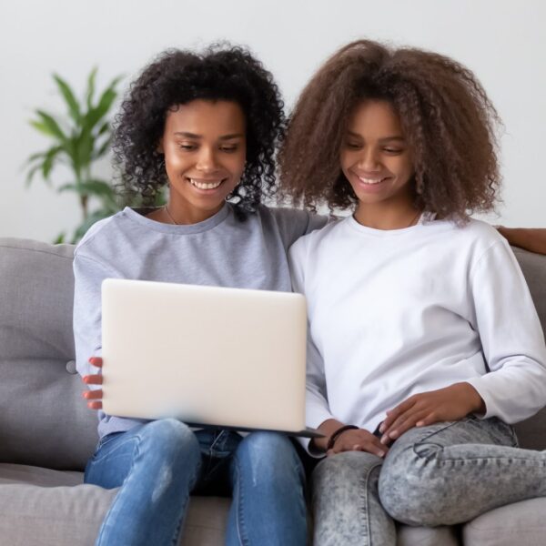 Happy,Family,African,American,Mother,And,Teen,Daughter,Looking,At