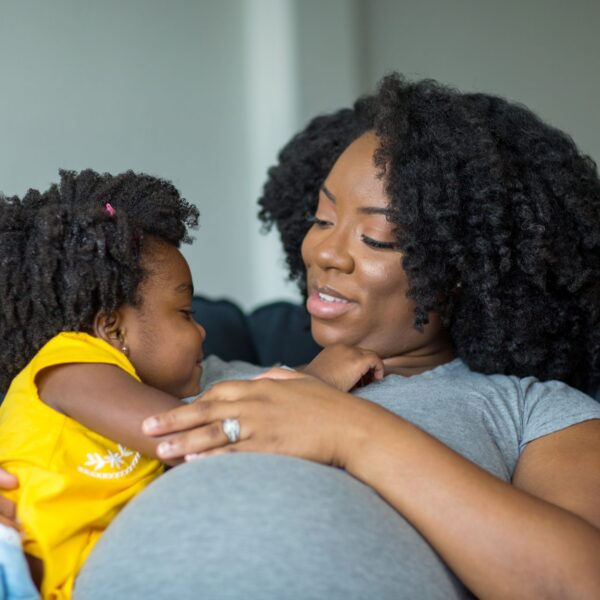 African,American,Little,Girl,Talking,With,Her,Pregnant,Mother.